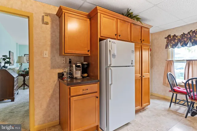 a kitchen with stainless steel appliances a refrigerator and a stove top oven