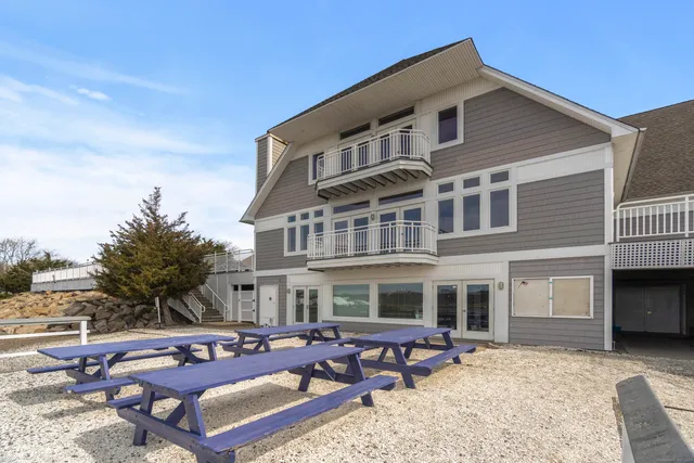 a front view of a house with outdoor seating