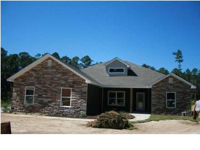 4555 Hermosa Road Crestview, FL 32539 - Photo 1 of 1 a front view of a house with a yard
