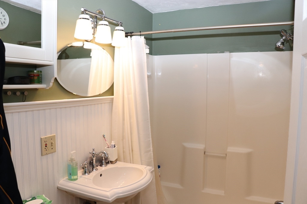 60 Edgehill Road Braintree, MA 02184 - Photo 21 of 30 a bathroom with a sink mirror and vanity