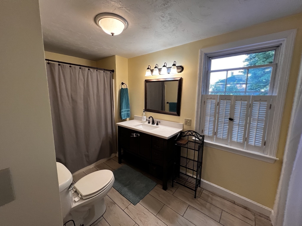 60 Edgehill Road Braintree, MA 02184 - Photo 24 of 30 a bathroom with a toilet a sink and a mirror