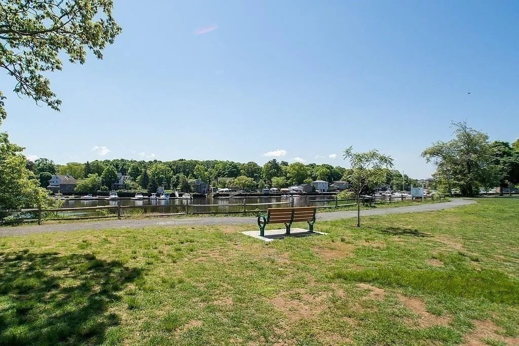 60 Edgehill Road Braintree, MA 02184 - Photo 29 of 30 a view of a lake with a bench and trees in the background