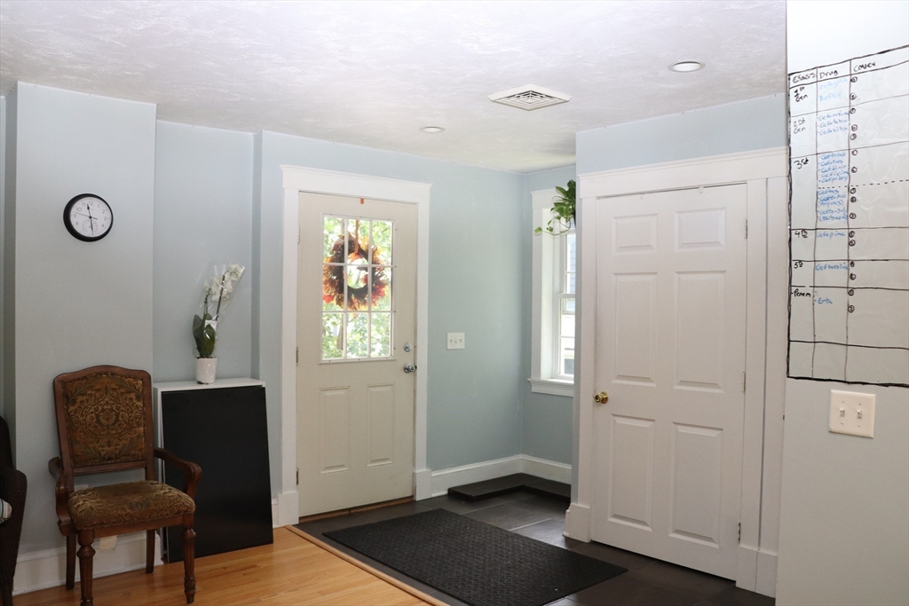 60 Edgehill Road Braintree, MA 02184 - Photo 8 of 30 a view of a hallway with wooden floor and windows
