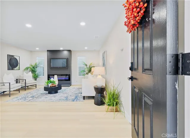 a living room with furniture and a potted plant