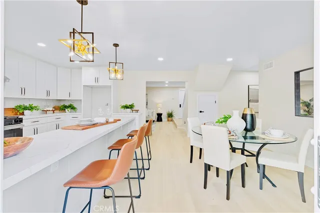 a dining room with furniture and a chandelier
