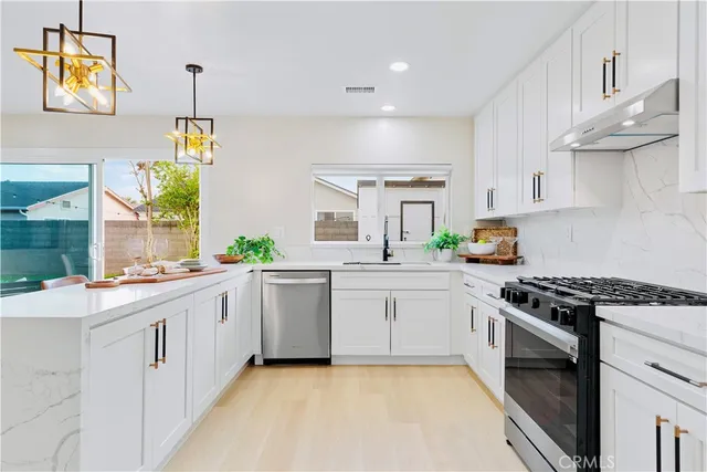 a kitchen with a sink stove and cabinets