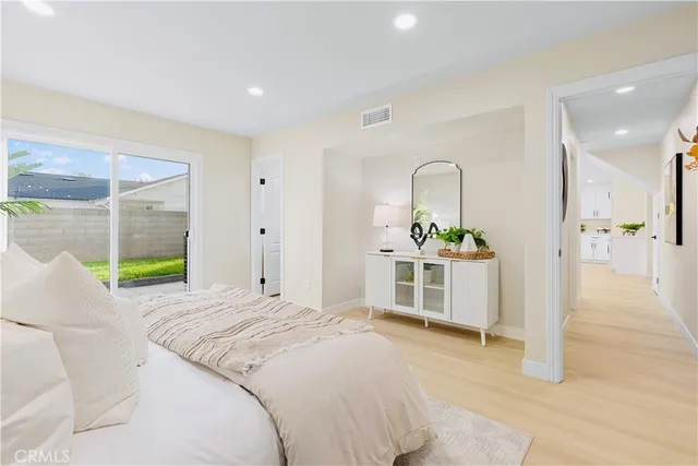 a bathroom with a granite countertop sink mirror vanity and toilet
