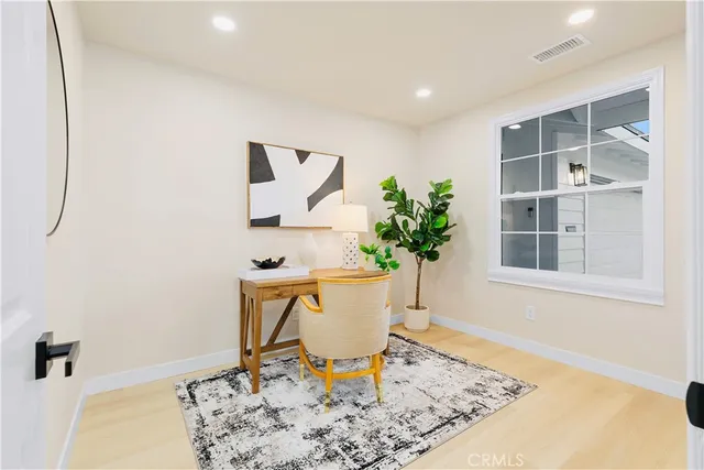 a view of a hallway to a livingroom and a dining room with furniture