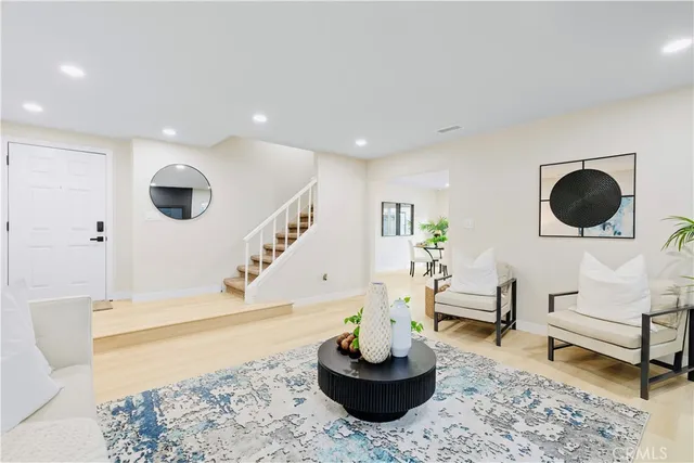 a living room with furniture and a potted plant
