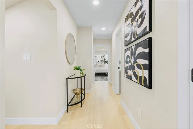 a spacious bedroom with a bed and a refrigerator