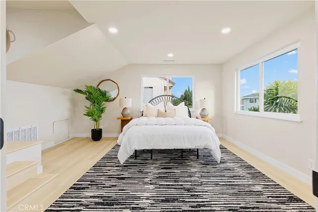 a bedroom with a large bed and a chandelier