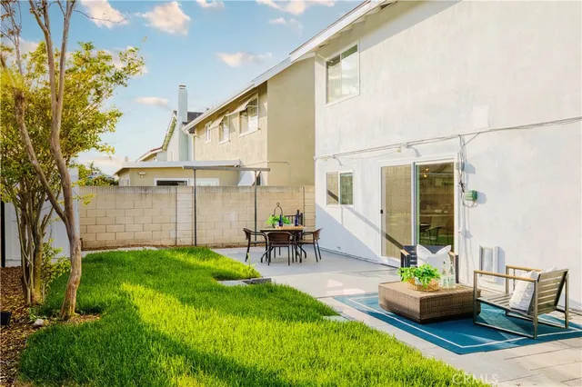 a view of a house with outdoor space and a car parked beside it