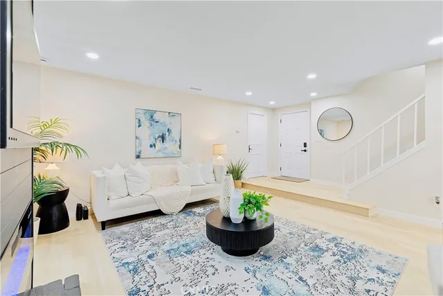 a living room with furniture and a potted plant