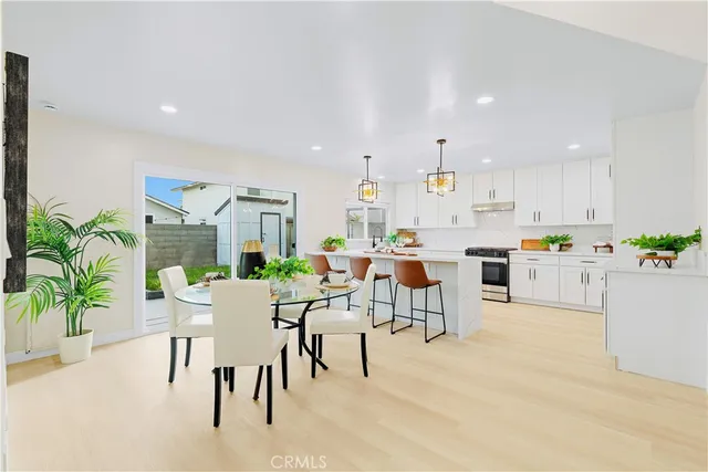 a living room with furniture and a dining table with kitchen view