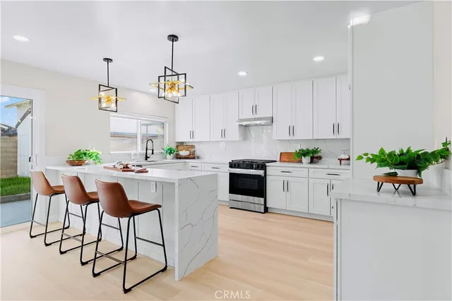 a kitchen with white cabinets and appliances