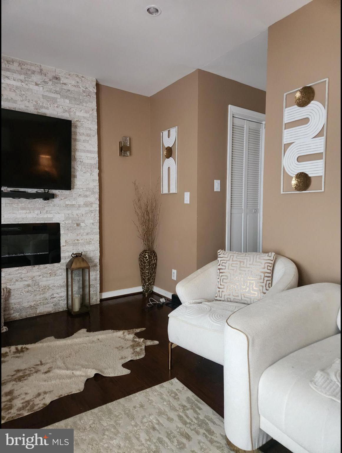 6346 Rockshire Street Alexandria, VA 22315 - Photo 8 of 10 a living room with furniture and a flat screen tv