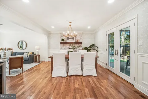 a dining room with furniture and wooden floor