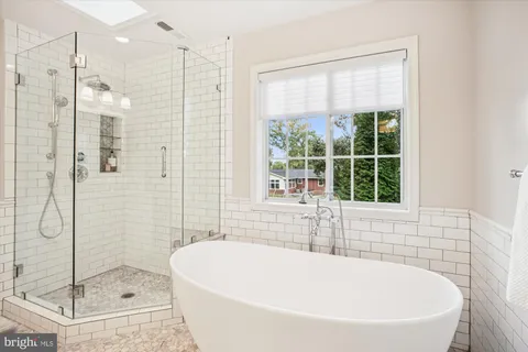 a bathroom with a bathtub and shower