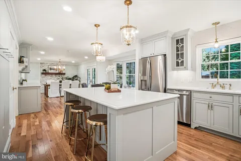 a kitchen with a table chairs refrigerator and microwave