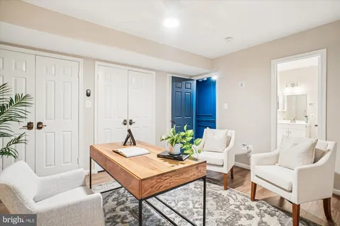 a view of a livingroom with a ceiling fan and staircase