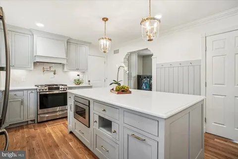 a kitchen with cabinets appliances and a sink