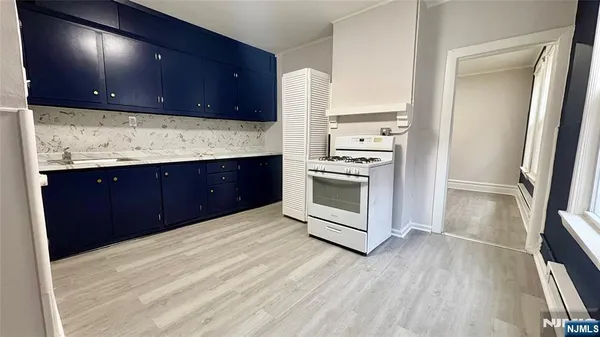 a kitchen with stainless steel appliances granite countertop a sink and a stove top oven