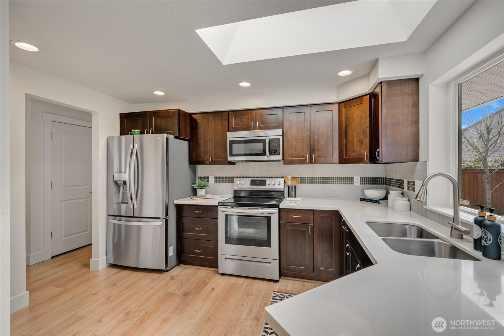 2 109th Place Southeast Everett, WA 98208 - Photo 6 of 40 a kitchen with stainless steel appliances a refrigerator a sink a stove a microwave and wooden floor