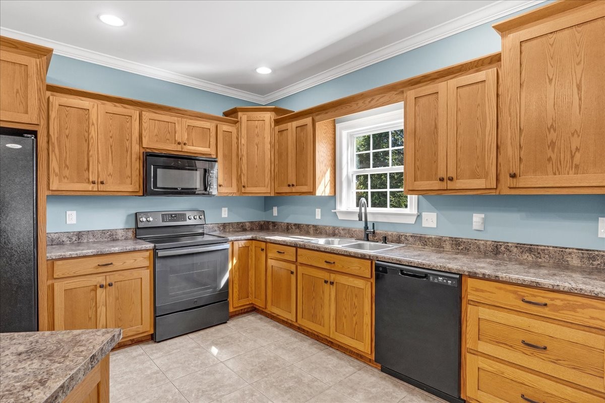 191 Mason Place Decherd, TN 37324 - Photo 19 of 53 a kitchen with stainless steel appliances granite countertop wooden cabinets a sink and dishwasher a stove top oven with wooden floor