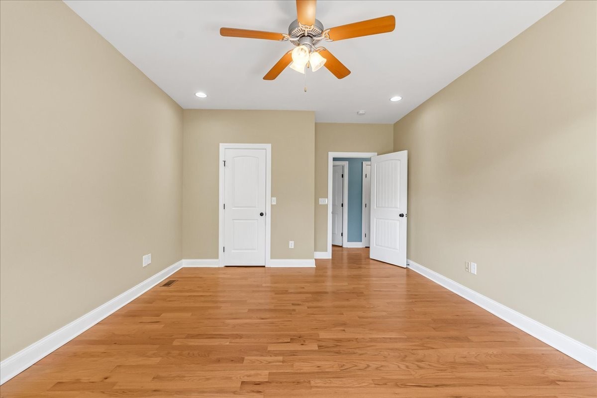 191 Mason Place Decherd, TN 37324 - Photo 29 of 53 a view of an empty room with chandelier fan and wooden floor