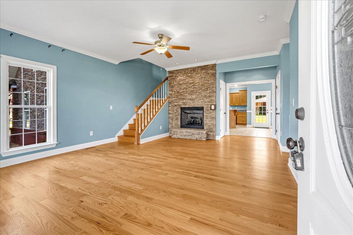 191 Mason Place Decherd, TN 37324 - Photo 8 of 53 a view of an empty room with wooden floor fireplace and a window