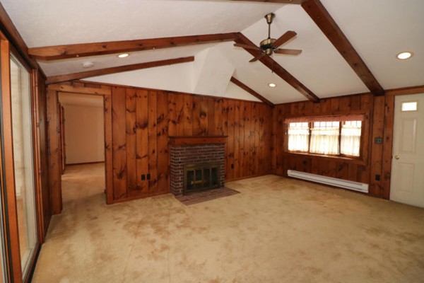 24 Mill Pond Road Orleans, MA 02653 - Photo 3 of 25 an empty room with a ceiling fan and window