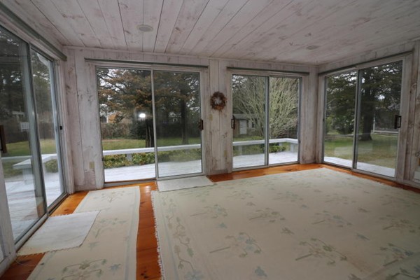 24 Mill Pond Road Orleans, MA 02653 - Photo 4 of 25 a view of an empty room with wooden floor and a balcony