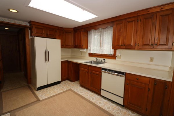 24 Mill Pond Road Orleans, MA 02653 - Photo 7 of 25 a kitchen with stainless steel appliances granite countertop a refrigerator a sink and dishwasher
