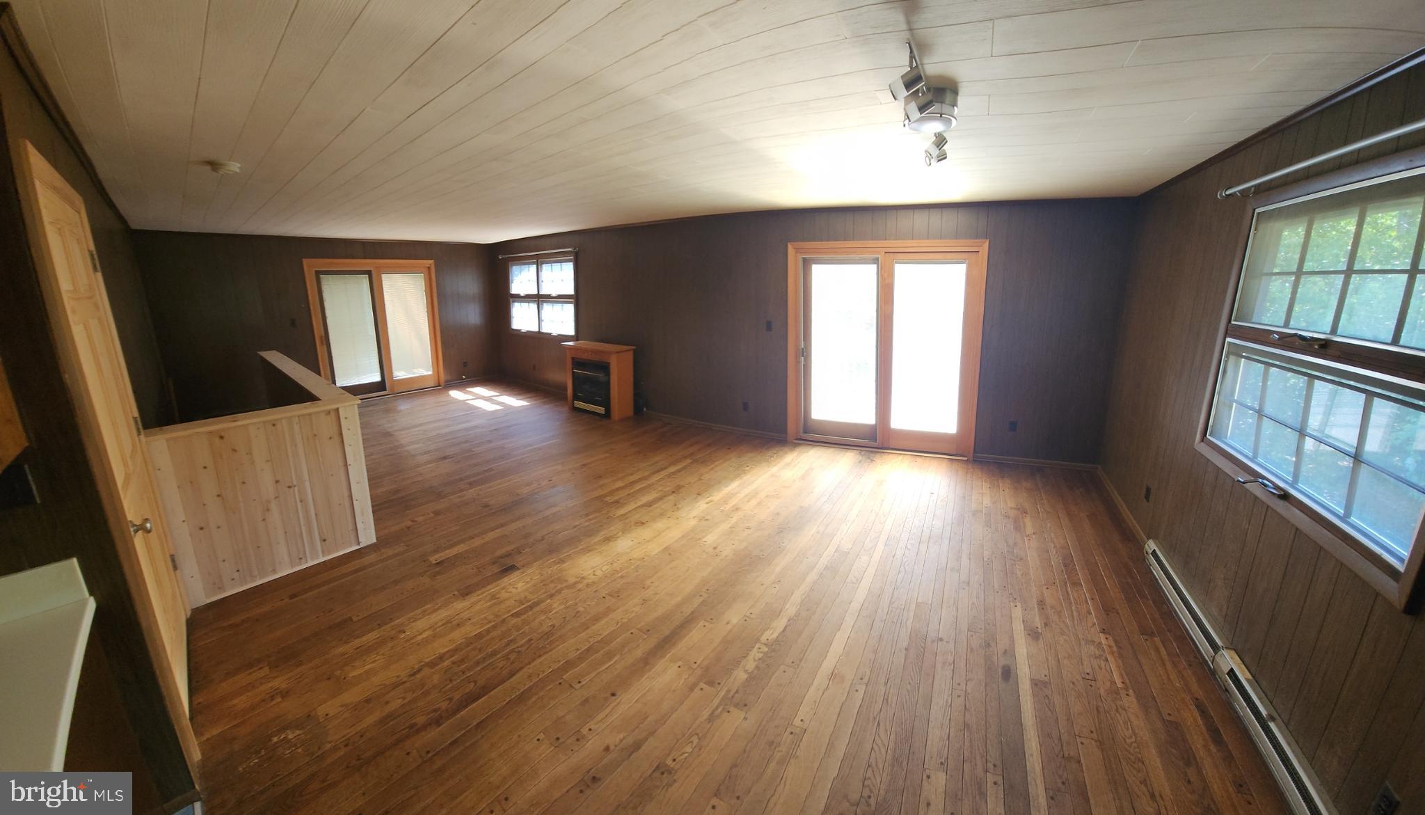 234 Hilltop Loop Road Harpers Ferry, WV 25425 - Photo 3 of 14 Living room w/2 Pella sliding doors and propane fp