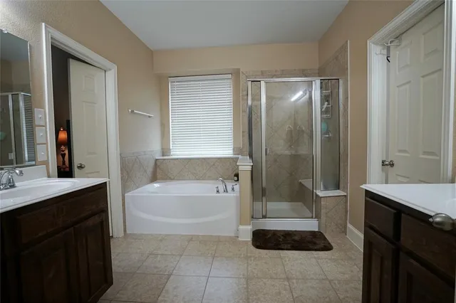 a bathroom with a bathtub a sink and a shower