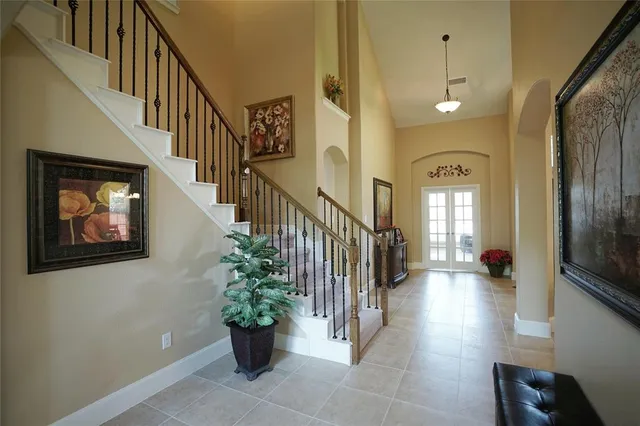 a view of a hallway with wooden floor and a potted plant