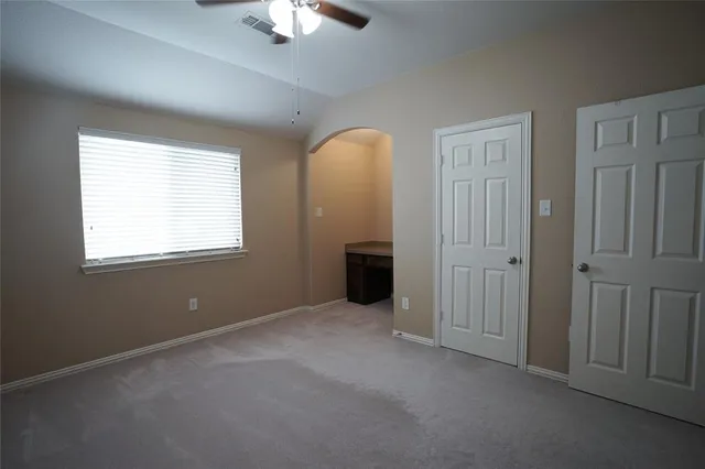 an empty room with windows and closet
