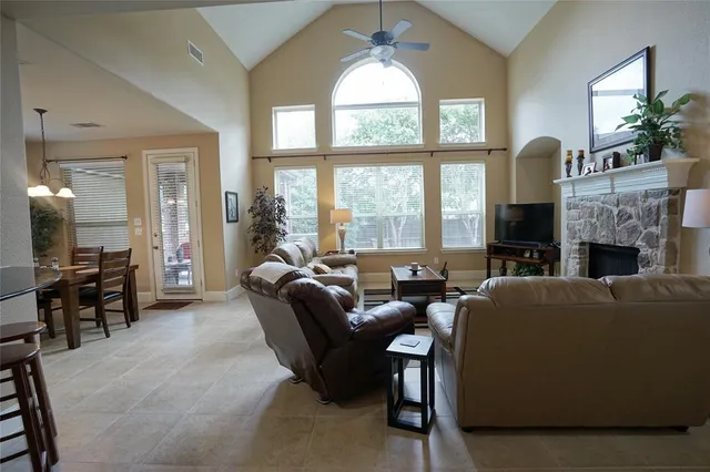 a living room with furniture a fireplace and a large window