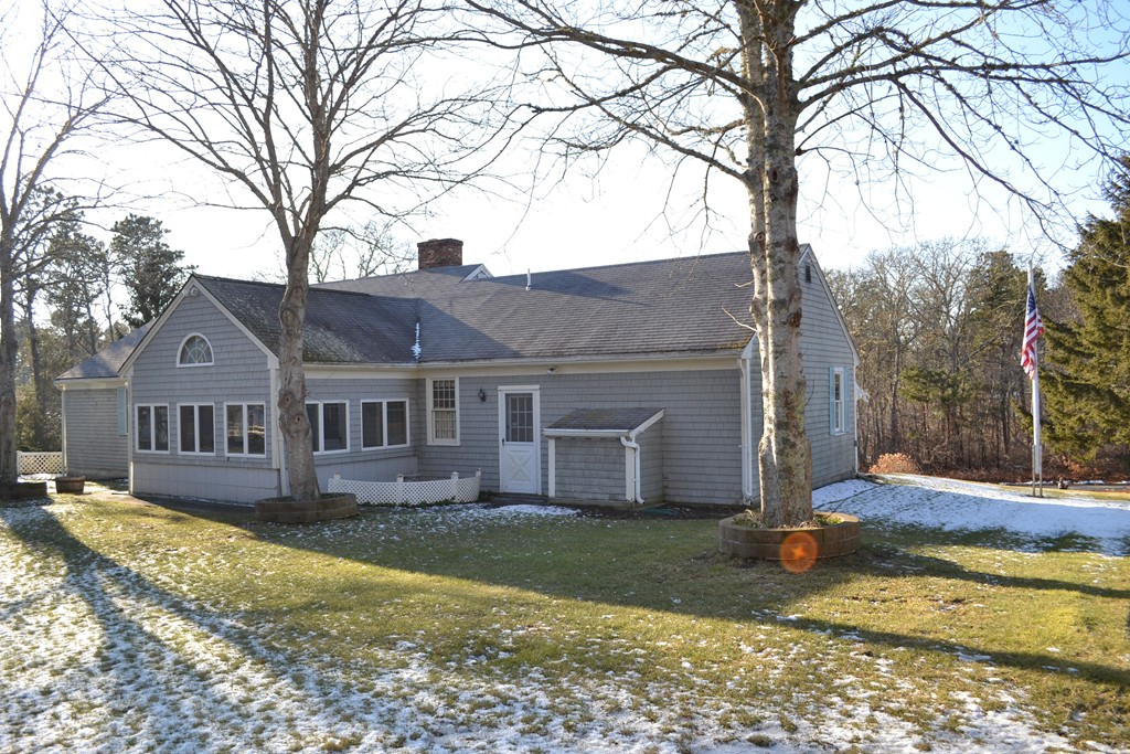 40 Joshua Jethro Road Harwich, MA 02645 - Photo 13 of 22 a front view of a house with a yard and large trees
