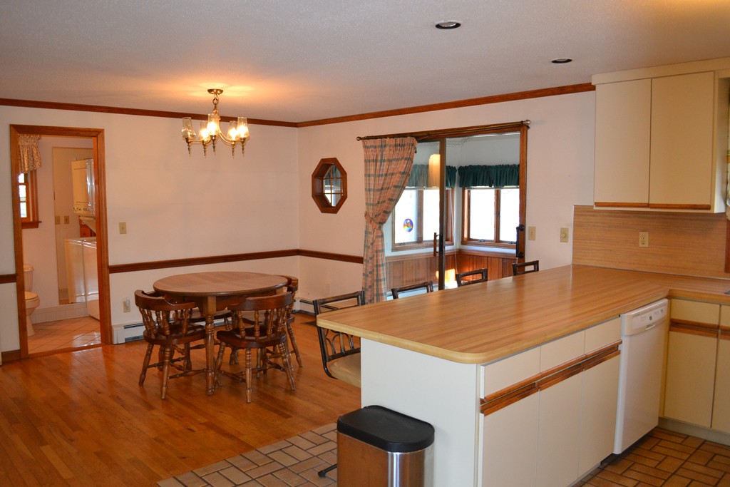 40 Joshua Jethro Road Harwich, MA 02645 - Photo 3 of 22 a view of dining table chairs and entryway with wooden floor