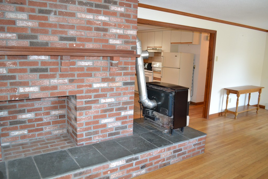 40 Joshua Jethro Road Harwich, MA 02645 - Photo 10 of 22 a view of a hallway with wooden floor and a living room