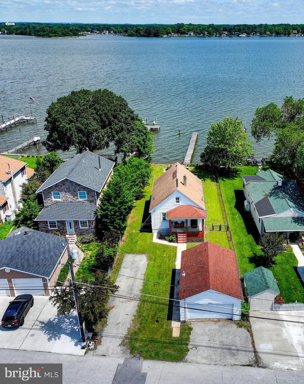 an aerial view of a house with outdoor space and lake view