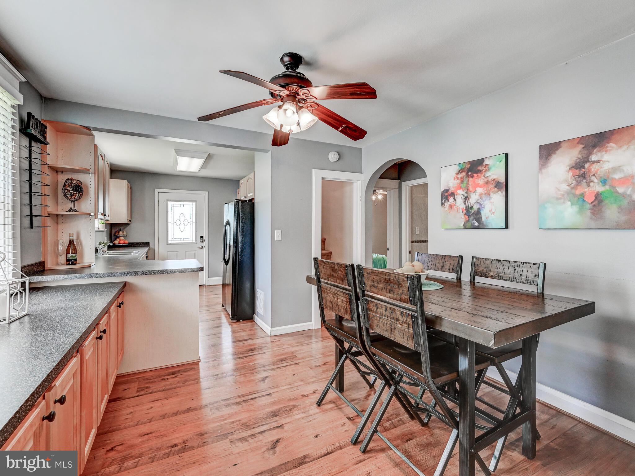 3932 Glenhurst Road Baltimore, MD 21222 - Photo 15 of 47 a view of a dining room with furniture and wooden floor