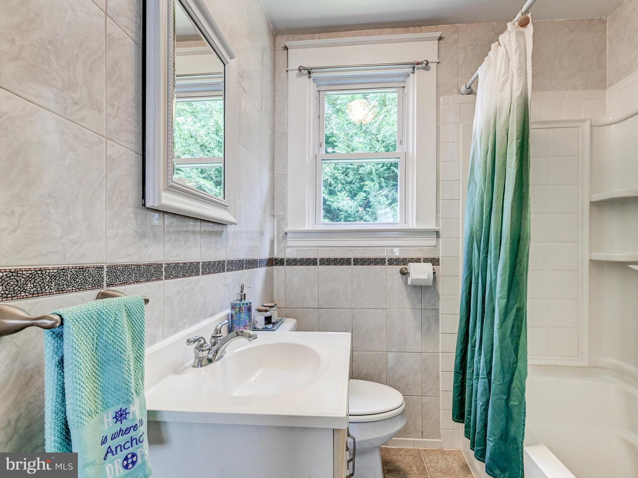 3932 Glenhurst Road Baltimore, MD 21222 - Photo 27 of 47 a bathroom with a sink toilet and shower