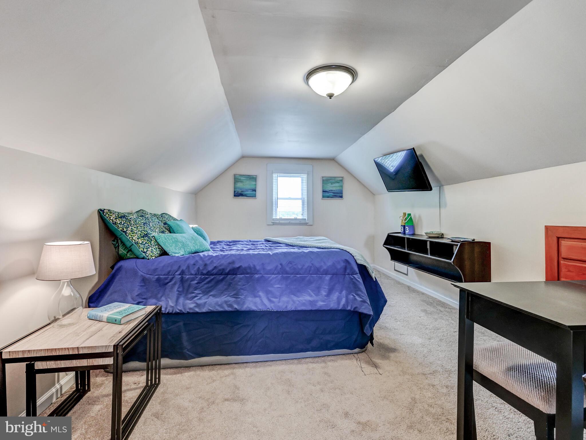 3932 Glenhurst Road Baltimore, MD 21222 - Photo 30 of 47 a spacious bedroom with a bed and a view of kitchen