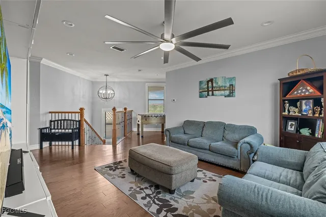 a living room with furniture and a book shelf