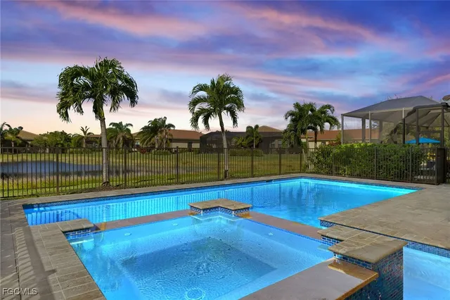 a view of swimming pool with a yard and palm trees