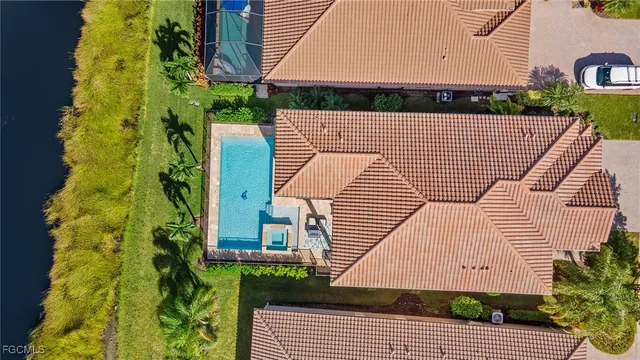 an aerial view of a house having yard swimming pool and outdoor seating