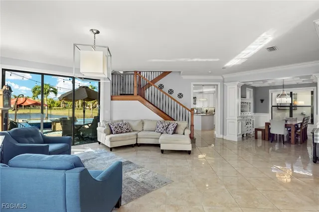 a living room with furniture and a chandelier
