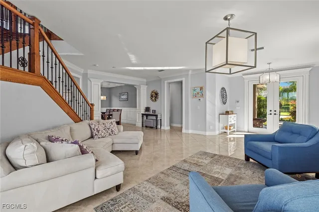 a living room with furniture ceiling fan and a rug